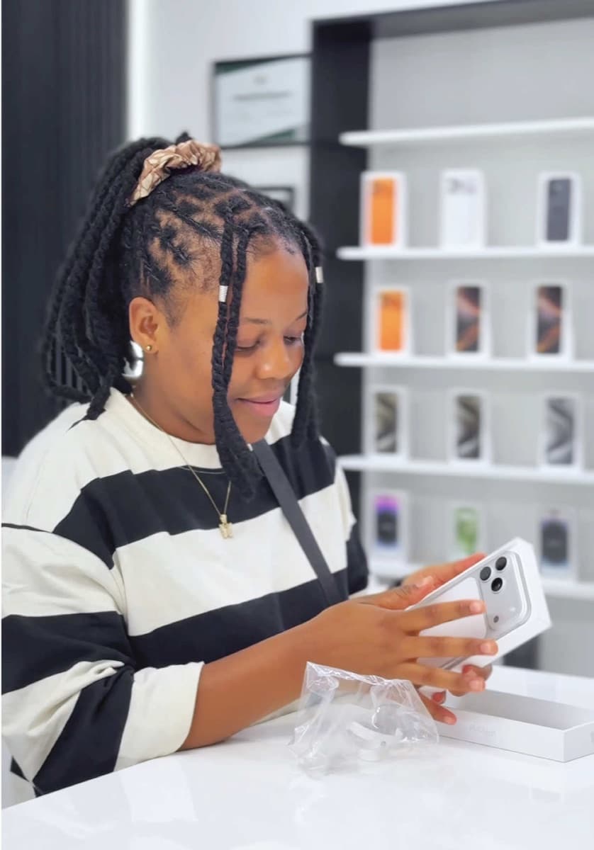 Switch Store customer opening a new iPhone in Harare